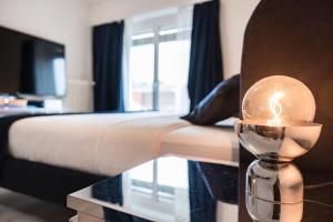 a bedroom with a bed and a candle on a table at Swiss Flat Rental in Lausanne