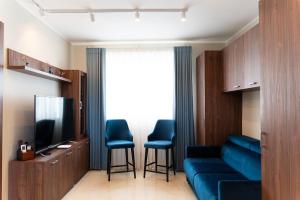 a living room with a couch and a television at Domus Boutique Hotel in Rabat