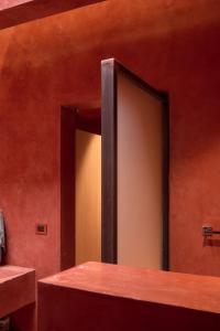 a mirror on the side of a wall in a room at Rojo Diseno Ubicacion Confort y AC in Oaxaca City