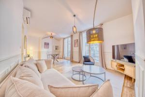 a living room with a couch and a table at L'étape Champenoise in Reims
