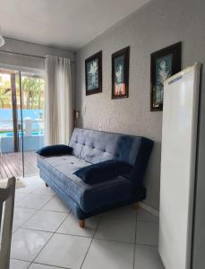 a living room with a blue couch in a room at Pousada Bella Praia in Torres