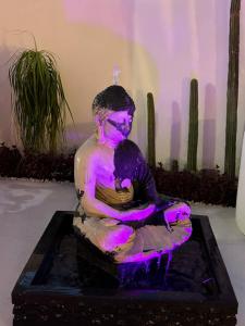 a statue of a person sitting in a fountain at Villa San Sebastian, Los Celajes in Acapulco