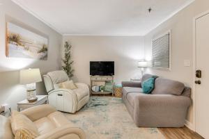 a living room with two couches and a tv at Wright by the Beach Hilton Head Condo with Perks in Hilton Head Island