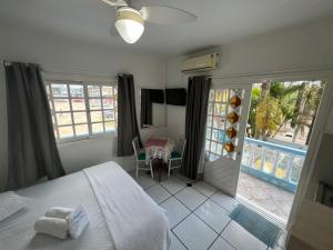a bedroom with a bed and a view of a patio at Pousada Bella Praia in Torres