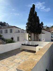 a bench sitting on top of a roof at Polina's Apartments in Hydra +21 photos