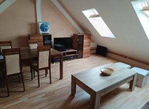 a living room with a table and a dining room at BellaCiaoApartment in České Budějovice