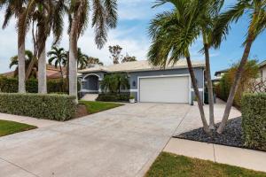 a house with palm trees and a driveway at 316 Marco in Marco Island