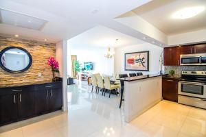 a kitchen and dining room with a table and chairs at Ocean Reserve 818 in Miami Beach