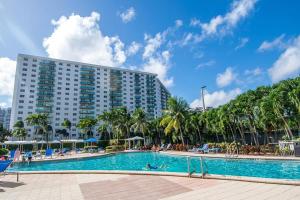 a swimming pool in front of a large building at Ocean Reserve 818 in Miami Beach