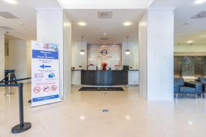 a lobby with a sign in the middle of a building at Ocean Reserve 818 in Miami Beach +30 photos