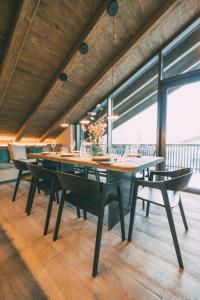 a dining room with a large wooden table and chairs at LIVALPIN Hideaway in Garmisch-Partenkirchen