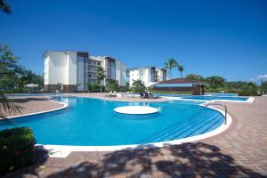 a large swimming pool in front of some buildings at Oceanfront Balcony Condo 2101 | Playa Bejuco + Sunset Views + Pool in Esterillos
