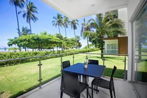 a table and chairs on a balcony with a view of the ocean at Oceanfront Balcony Condo 2101 | Playa Bejuco + Sunset Views + Pool in Esterillos
