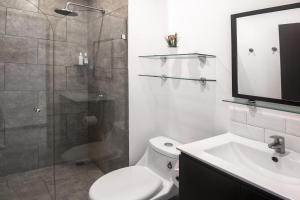 a bathroom with a shower and a toilet and a sink at Oceanfront Balcony Condo 2101 | Playa Bejuco + Sunset Views + Pool in Esterillos +19 photos