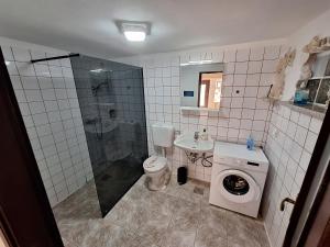 a bathroom with a shower and a toilet and a sink at Zonnemarie in Mošćenička Draga +40 photos