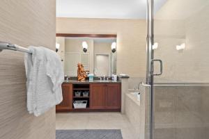 a bathroom with a shower and a sink at Halii Kai 20D in Waikoloa +37 photos