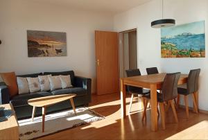 a living room with a table and a couch at Ferienwohnung C10 in Orselina