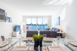 a dining room with a table with wine glasses at Golden Bay 406 in Miami Beach