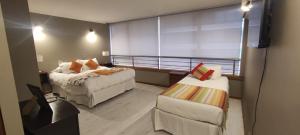 מיטה או מיטות בחדר ב-Apart Hotel Aragon Portal