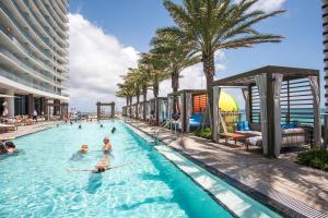 a group of people in a swimming pool at a hotel at Lyfe Beach Resort 3804 in Beverley Beach