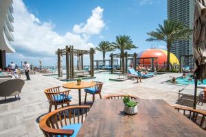 a patio with a table and chairs and a pool at Lyfe Beach Resort 3804 in Beverley Beach