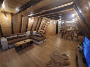 a living room with a couch and a table at Krushevski Konaci 2 in Kruševo