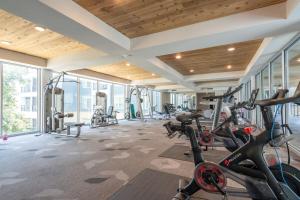 a gym with bikes and treadmills in a building at Trendy Riverwalk Retreat King Bed Free Parking Pool Gym in San Antonio