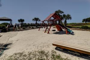 a playground on the beach with a bench at Island Club in Hilton Head Island
