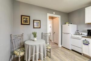 a kitchen with a table and a white refrigerator at 4 Mi to Baton Rouge Charming Duplex Apartment in Port Allen