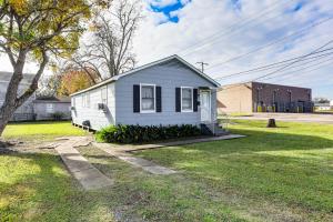 a small white house in a grassy yard at 4 Mi to Baton Rouge Charming Duplex Apartment in Port Allen