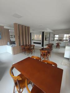 a dining room with wooden tables and chairs at Pousada Azimute in Torres +22 photos
