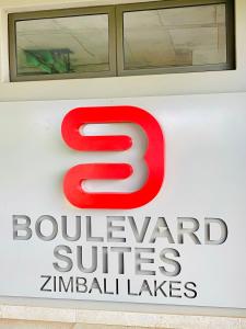 a red sign on the side of a building at Boulevard suite 242 in Ballito