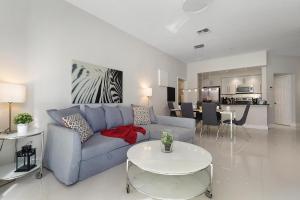 a living room with a blue couch and a table at One in a Minion #102 in Orlando