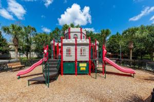 a playground with a slide in a park at One in a Minion #102 in Orlando