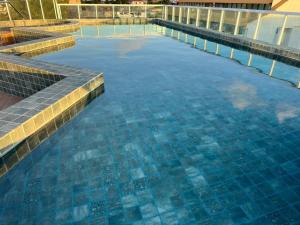 a swimming pool with blue tiles on top of it at EcoMirage - Flats Premium - Porto de Galinhas in Porto De Galinhas