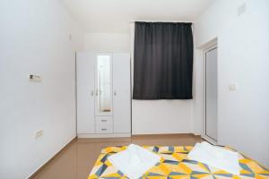 a bedroom with a mirror and a bed at Apartments Nahla in Bar +61 photos