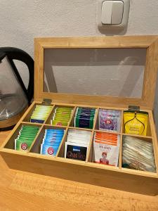 a wooden box filled with different types of books at Pretty half-timbered cottage on romantic yard in Fuldabrück