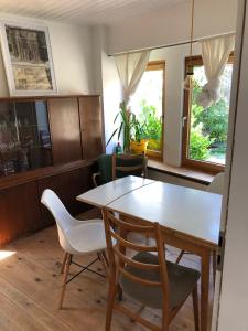 a dining room with a table and chairs at Pretty half-timbered cottage on romantic yard in Fuldabrück