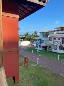 a view of a building with a green yard at Recanto Brisas de Imbassaí Village C18 in Mata de Sao Joao