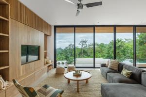 a living room with a couch and a table at Casa Roca in Santa Teresa Beach