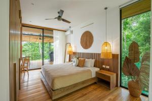 a bedroom with a bed and a large window at Casa Roca in Santa Teresa Beach +34 photos