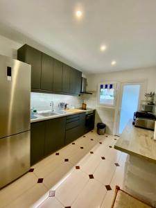 a kitchen with a refrigerator and a tile floor at Apartment-House La Mata Torrevieja in Torrevieja