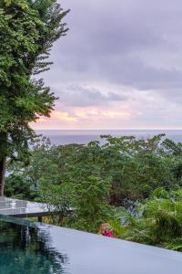 a view of the ocean from a resort swimming pool at Casa Roca in Santa Teresa Beach