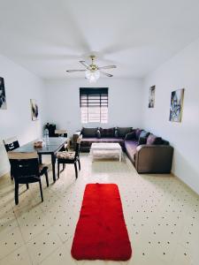 a living room with a couch and a red rug at Beautiful home in Tangier Beau Site Parking in Tangier