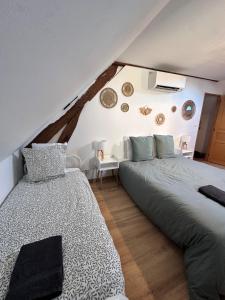 a bedroom with two beds in a attic at La Ruche in La ForestiÃ¨re +29 photos