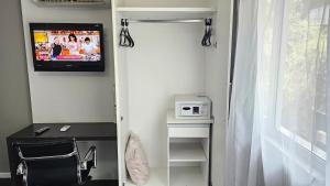 Un televizor și/sau centru de divertisment la Flat Pampulha orla prox Mineirão com varanda
