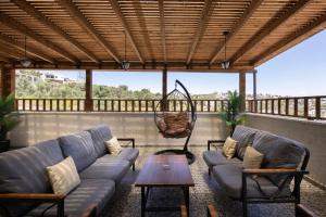 a living room with a couch and a table at וילה לה מונטנייה in Dāliyat el Karmil