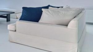 a white couch with two pillows on top of it at Premium Villa Agia Anna Mykonos in Platis Yialos Mykonos