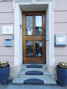 a front door of a house with blue mats in front at AMADEA - Cityhotel Salzburg in Salzburg