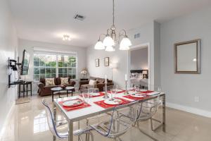 a dining room and living room with a table and chairs at Mickey Mouse #104 in Orlando